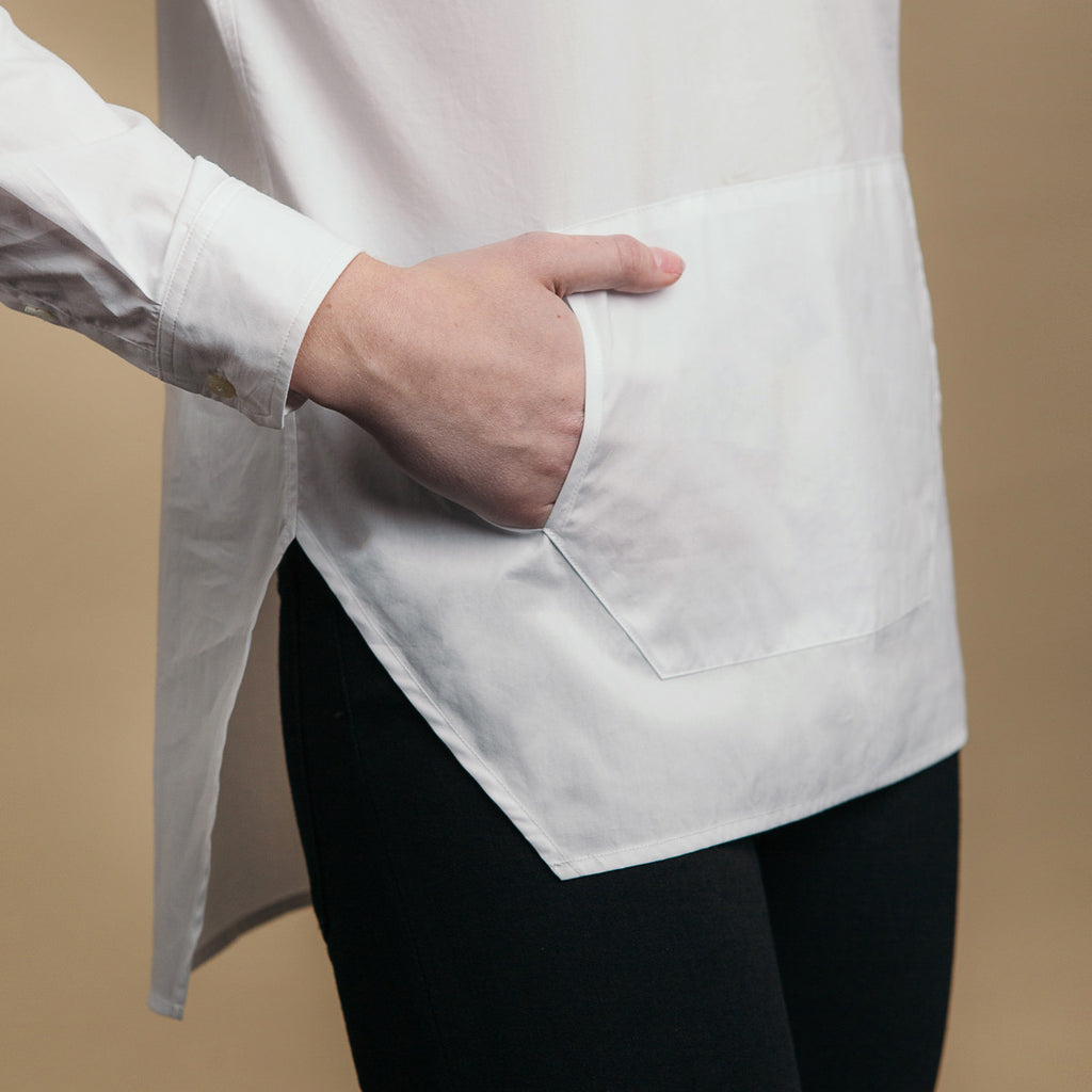 The Trapezoid Pullover - Paper White. Side view detail. Straight angled hem.