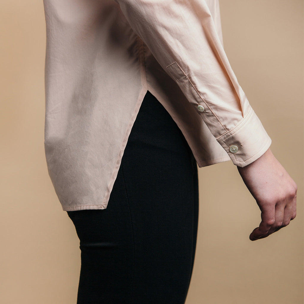 The Trapezoid Shirt - Dusty Blush. Side view, angled hem meets at point.