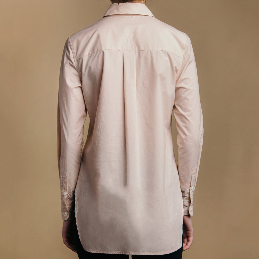 The Trapezoid Pullover - Dusty Blush, back view. Box pleat, real shell cuff buttons. 