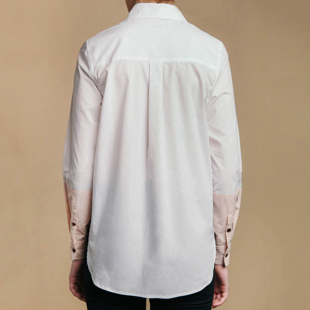 The Hand-Dipped Shirt - Paper White/DustyBlush, back view. Box pleat, cuff placket buttons. 